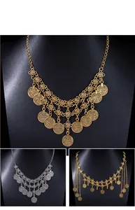 Detailed view of vintage bohemian ethnic metal coin fringe jewelry in gold and silver