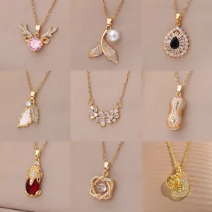 Selection of nine elegant gold-plated necklace pendants featuring crystals, pearls, and gems.