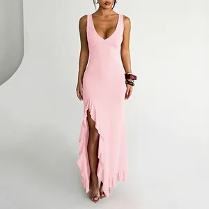 Detailed studio shot of a sexy pink V-neck maxi dress featuring a high ruffled slit design