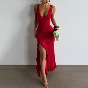Detail shot of the ruffled hem and high leg slit on a sexy red V-neck maxi dress