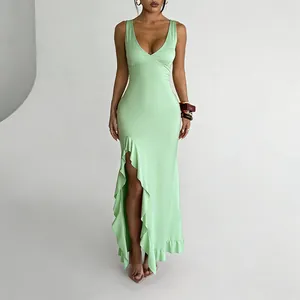 Full view of mint green V-neck maxi dress with high ruffle slit detailing.