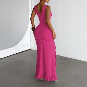 Back view of a vibrant pink maxi dress featuring a V-neckline and ruffled hem detail.