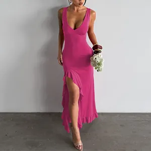 Detail of pink V-neck dress featuring high split hem and delicate ruffled edges.