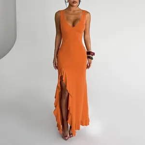 Close-up of vibrant orange V-neck dress featuring elegant ruffles and high leg slit