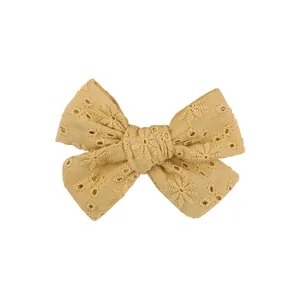 Detailed macro view showing the yellow eyelet embroidery on this kids bow hair clip