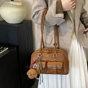 Vintage brown faux leather bowling style underarm bag with front pockets and teddy charm
