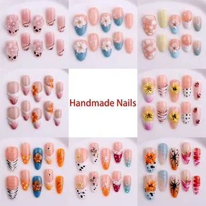 Detailed view of various handmade floral and patterned wearable press-on nails set
