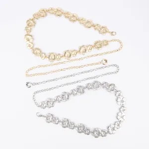 Detail shot of vintage bohemian metal flower waist chains in gold and silver finishes.