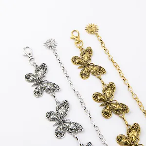 Macro view of vintage butterfly metal waist chains with intricate gold and silver details