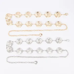 Detailed view of fashionable gold and silver sunburst metal waist chains for women.