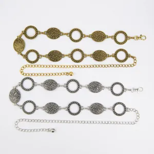 Detailed view of vintage Bohemian metal waist chains in gold and silver for dresses