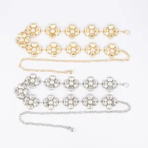 Detail view of elegant floral metallic waist chains in gold and silver with pearl centers