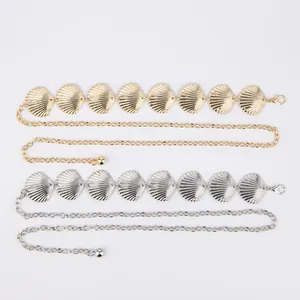 Detail showing gold and silver metal waist chains with decorative shell elements for women
