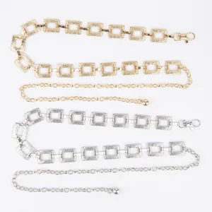 Detail of gold and silver bohemian metal waist chains with textured square links