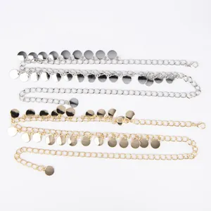 Detail view of stylish gold and silver metal waist chains with round disc charms.
