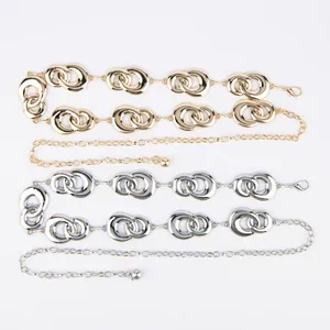 Detailed view of gold and silver vintage metal waist chains featuring interlinked double rings