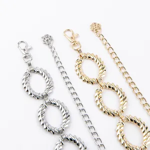 Detailed view of gold and silver metal waist chains with elegant twisted ring links