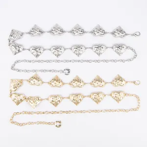 Detailed view of gold and silver heart-shaped metal waist chains with textured finish.