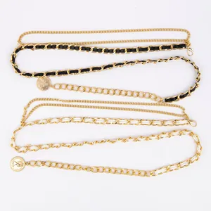 Detailed macro view of dual-layer gold waist chains with black and white leather accents