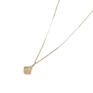 Elegant gold-tone chain necklace featuring a geometric pendant with shimmering stones