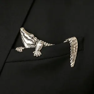 Vintage silver-toned crocodile animal brooch pinned on a black suit pocket for men