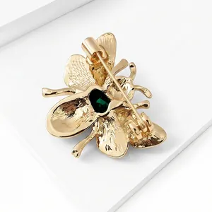 Fashionable gold-tone alloy bee brooch pin for women with a green gemstone accent