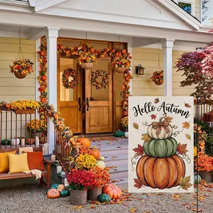 Decorative autumn garden flag featuring a pumpkin stack and Hello Autumn greeting on a porch