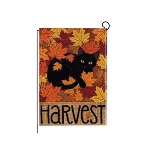 Decorative autumn harvest garden flag featuring a black cat among colorful maple leaves