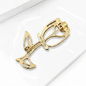 Elegant gold alloy hollow-out rose brooch floral pin for women minimalist fashion jewelry.