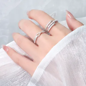 Detailed view of silver rings with sparkling cubic zirconia on a female hand