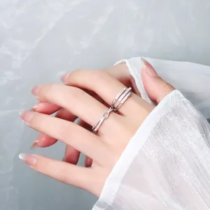 Detailed macro view of silver geometric crossover open ring with sparkling cubic zirconia.