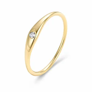 Minimalist gold s925 sterling silver thin ring with a single bezel-set sparkling zircon.