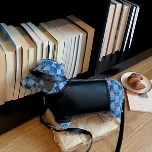 Detail shot of a creative dog-shaped denim and leather crossbody bag by a bookshelf