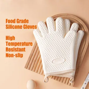 Heat resistant cream silicone oven gloves with heart texture on wooden board