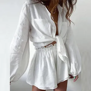 Elegant white linen two-piece set with long sleeve shirt and matching high waist shorts.