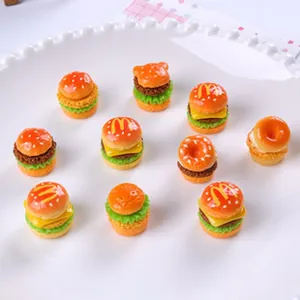 Close-up of miniature resin hamburgers and cat-shaped buns for DIY crafts