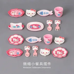 Detailed macro view of cute miniature cat-themed dollhouse tableware and cutlery set