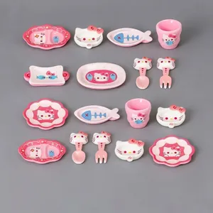 Detailed macro view of cute miniature cat-themed dollhouse tableware and cutlery set