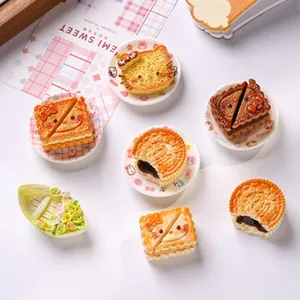 Detailed close-up of various miniature cat-themed cakes and cookies for DIY craft projects