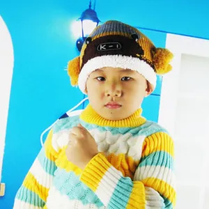 Asian child wearing a colorful striped knitted sweater and monkey style beanie hat