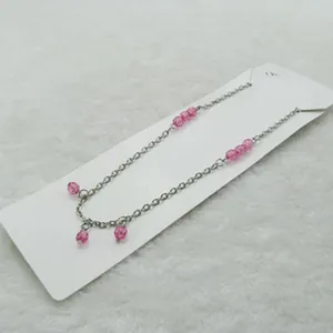 Silver-toned delicate chain necklace featuring faceted pink translucent beads detail