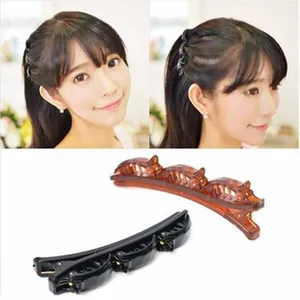 Detailed view of black and tortoiseshell double-layer hair clips for stylish braiding