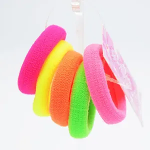 Detail view of colorful soft towel-fabric hair scrunchies for children in pink and yellow.