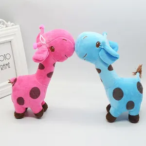 Detailed close-up of cute pink and blue plush giraffe dolls with soft embroidered faces