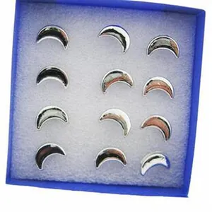 Close-up of 12 silver crescent moon hair clips arranged in a blue display box