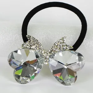 Close-up of elegant hair tie featuring large heart-shaped crystal butterfly wings