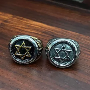 Detailed macro view of vintage stainless steel military rings with Star of David engraving