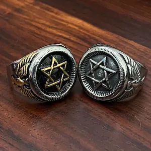Close-up of vintage stainless steel military rings with hexagram and eagle wing detail