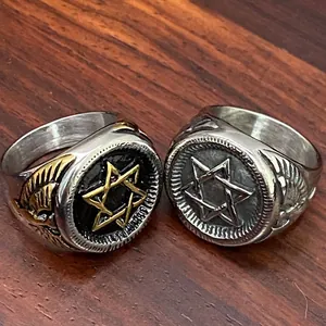 Close-up of vintage stainless steel hexagram rings with detailed eagle wing engravings