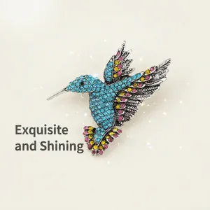 Detailed macro view of vintage silver hummingbird brooch with colorful rhinestones